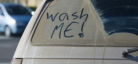 Wash me written on a dirty car window